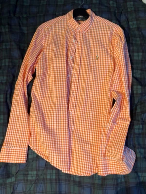  skjorta från Ralph Lauren Slim fit -  långärmad skjorta från Ralph Lauren i orange och vitt rutigt mönster. Klassisk krage riktit stilig på sommarn Slim fit
