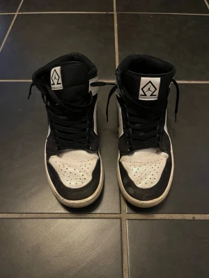 Svarta och vita Jordan 1 diamond Mid - Säljer ett par Air Jordan 1 Mid svart och vitt, Slitna men går fortfarande att använda bra och dem är snygga, har kartongen kvar.  Meddela för snabb affär  Pris 900kr men kan diskuteras
