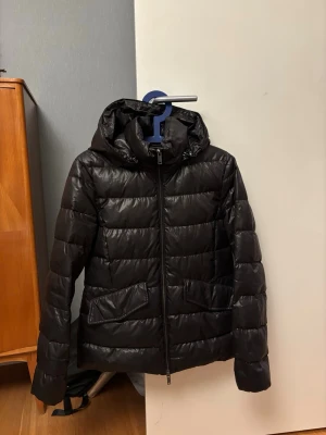 Svart pufferjacka - Snygg svart glansig pufferjacka från Massimo Dutti med huva och dragkedja framtill. Fråga om du undrar något mer!🥰