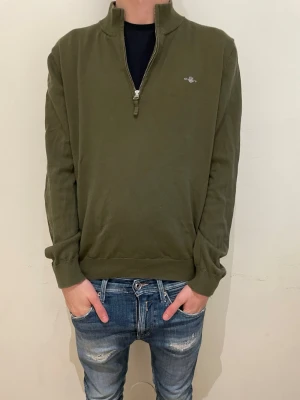 Gant half zip - Säljer en stilren olivgrön Gant half zip. Modellen på bilden är 170cm. Priset är inte hugget i sten. Hör av dig för mer information.😃✌️