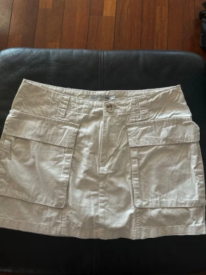 Beige cargokjol - Säljer en beige kortkjol från lager 157 i storlek M, som har 2  fickor framtill. Mycket bra skick💕