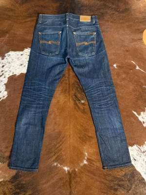Nudie GrimTim DrySelvage - Tjena! Säljer dessa riktigt feta nudie GrimTim det selvage jeans, byxorna är i fint skick med snygg wash, byxorna är otvättade, W31/L32, finns ett hål i ena ficka, hör av dig vid funderingar!🙌