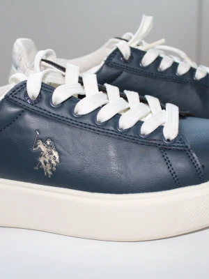  sneakers från U.S POLO ASSN  - Snygga mörkblå sneakers  med vit sula och vita skosnören. Klassisk låg modell med silverfärgad logga på sidan. Perfekta för dig som gillar stilrena och tidlösa sneakers med premiumkänsla.