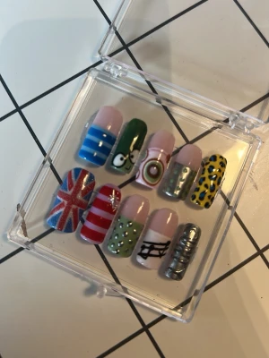 Färgglada press-on naglar med mönster - Säljer ett set press-on naglar i olika färger och mönster!                                        Tumme: 12mm Pek: 9mm Lång: 10mm Ring: 9mm Lill: 8mm