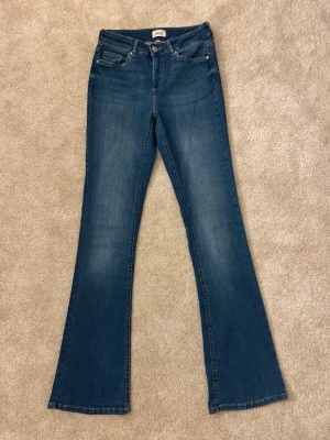 Blå bootcut jeans från Only  - Mid waist och M i midjestorlek och 34 i benlängd. 