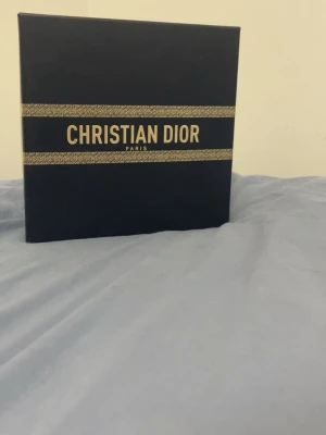 Dior Sauvage Eau de Parfum presentbox - Lyxig presentbox från Christian Dior med parfymen Sauvage Eau de Parfum. Boxen är mörkblå med gulddetaljer och innehåller en svart parfymflaska i elegant förpackning. Perfekt för dig som gillar exklusiva dofter och snygg design. Äkta 
