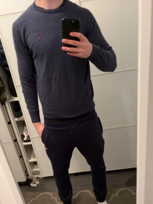 Merinoull tröja Ralph lauren - Mörkblå stickad tröja från Polo Ralph Lauren med rund halsringning och diskret broderad logga på bröstet. Tröjan har en klassisk passform och är tillverkad i mjukt material som känns skönt mot huden. Storlek S. Modellen på bilden är 180 cm. Vid funderingar är det bara att skriva. Vid snabb affär kan priset diskuteras.