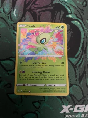 Pokémonkort Celebi holografisk - Säljer ett färgglatt holografiskt Pokémonkort med Celebi-motiv. Kortet har gul ram och livfull bakgrund i flera färger. Text och effekter på engelska. Perfekt för samlare eller Pokémonfans som vill utöka sin kortlek.