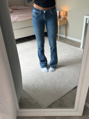 Mörkblåa bootcut jeans, Midwaist - Säljer ett par mörklblåa midwaist bootcut jeans med vita sömmar. Storlek 170 men passar mig som har xs-s. Okänt märke.