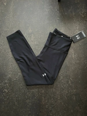 Under Armour leggings  - Svarta ankle leggings från Under Armour med hög midja och kompressionseffekt.  Stl M                   Helt ny Nypris (599)