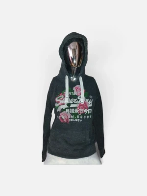 Mörkgrå hoodie med rosor från Superdry - Cool mörkgrå hoodie från Superdry med vit logotyp och japanska tecken på bröstet. Dekorerad med rosa rosor och gröna blad, samt vita snören i huvan. Praktisk magficka och långärmad design. Perfekt för dig som gillar streetstyle och snygga detaljer.