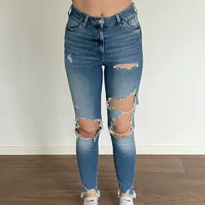 Blåa håliga jeans från H&M i storlek 34. Helt okej skick.