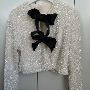 Glittrig-tröja - Jättefin glittrig-tröja från H&M. Bara använd en gång. Lite kortare passform som man knyter. Inklusive frakt