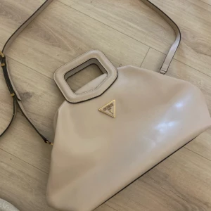 Guess Handväska light rum - Köpt på Zalando Nypris: 1545 kr Använd några gånger bra skick Beige