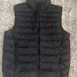 POLO RALPH LAURENTHE PACKABLE GILET - VÄST - Hej! Säljer nu min Ralph Lauren dunväst eftersom den var lite för stor. Därför har jag knappt använt den. Konditionen är därav mycket bra, 9/10. Den är slutsåld i princip överallt och nyprisset är ungefär ~3300kr. Pris kan alltid diskuteras! 