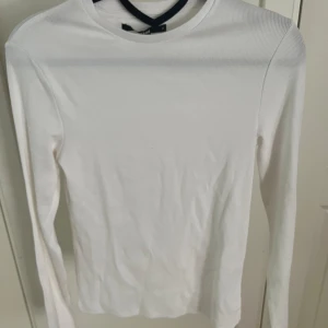 Vit ribbad långärmad - Vit ribbad långärmad från Bik Bok, storlek M men passar även S. Nyskick, helt oanvänd.