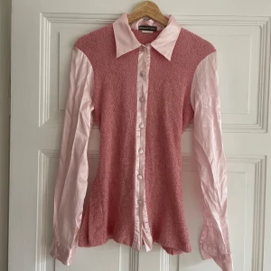 Vintage rosa skjorta 💗 - Jättefin och speciell skjorta med kontrast av två olika tyg 💗Den sitter väldigt fint på då man kan knyta den där bak 🤭Passar storlek S! 