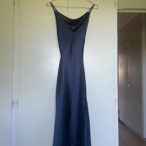 Marinblå midiklänning  - Marinblå midiklänning med slits från Asos design, Storlek 32!   Använd 1 gång!  Bifogade två bilder på hur klänningen ser ut från hemsidan men hittade endast bilder på klänningen i färgen rosa. Klänningen jag säljer är marinblå!
