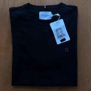 Svart T-shirt  - Helt ny och oanvänd T-shirt med prislapp på från Les deux.   Rensar ur min garderob från en hel del oanvända kläder🌼 Om du ser något mer i min profil som du gillar så skickar jag med det till dig också!😊 Fler kläder kommer! 