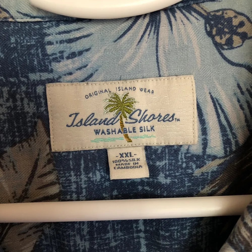 Hawaiiskjorta köpt i Arizona, skön silke som tål tvätt. Alla knappar finns, ren och snygg. Ett pyttelitet hål bak långt ner som inte syns.. Skjortor.