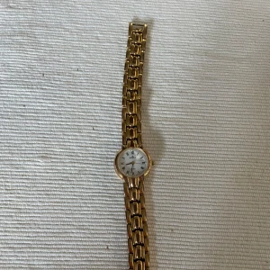 Guldklocka  - Jättefin guldig klocka från Dugena! Klockan är rostfritt stål! Kan gå ner i pris vid snabb affär!