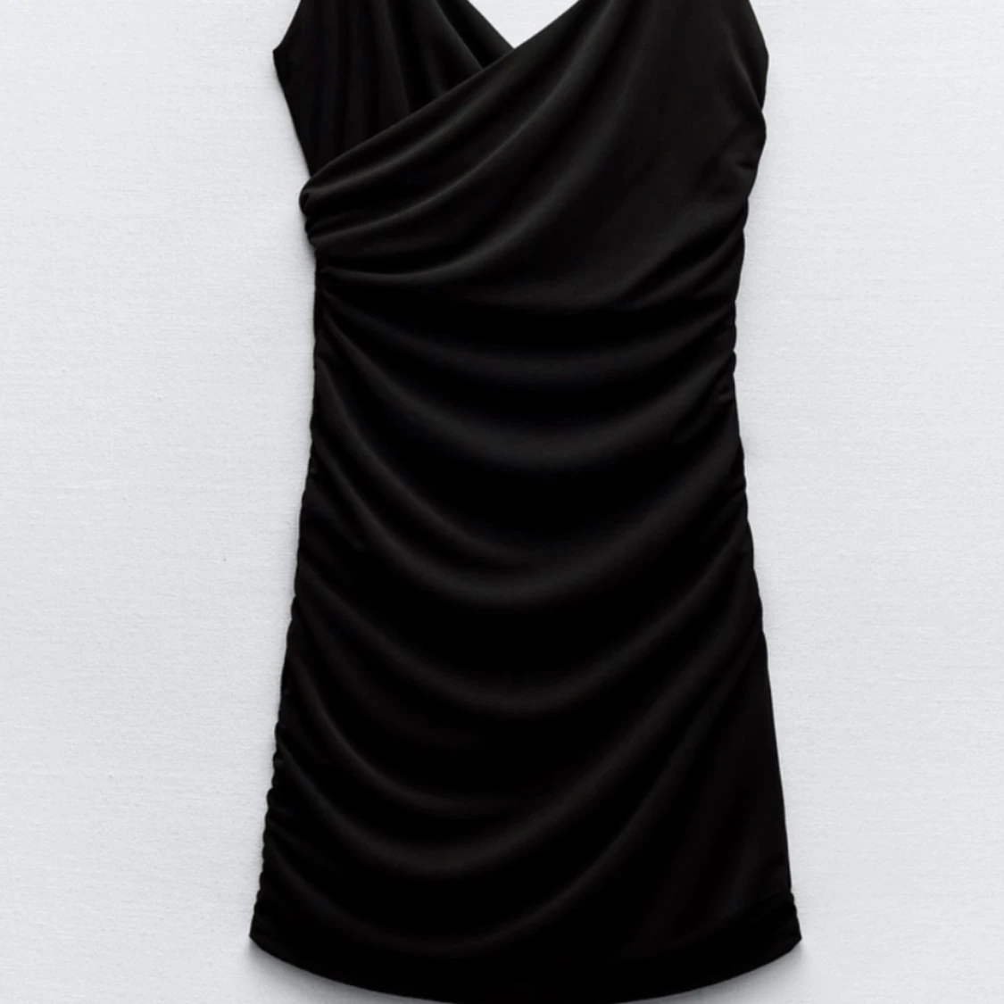 Svart draperad klänning