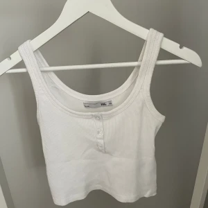 Topp/linne  - Vit topp/linne med söta knappar från Lager157 i storlek XS. Aldrig använd så nyskick!✨ Köparen står för frakten, kan mötas upp i Kalmar!