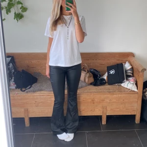 Utsvängda byxor - Säljer dessa så snygga bootcut byxor i skinn liknande material. Materialet är stretchigt så byxorna kan passa flera storlekar. Midjemått: 36-40 cm Innerbenslängd: 78 cm   