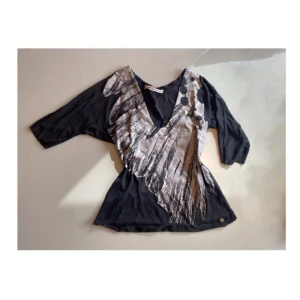 Trekvartsarm svart tröja - Köpt på secondhand. Väldigt mjuk och sitter bra på. Väldigt urringad. 