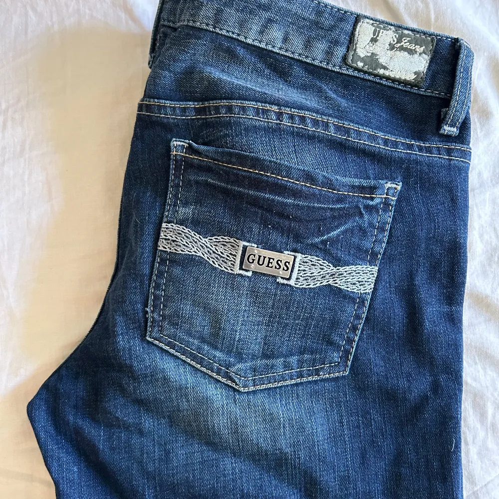 Skit snygga lågmidjade mörkblåa Guess jeans som inte kommer till användning. Står w30, och satte väldigt bra på mig i storlek 38. Skit snygga detaljer på fickorna och framsidan. Innerbenslängden: ca 81-82cm Midjemått: 30w (enligt lappen). Jeans & Byxor.