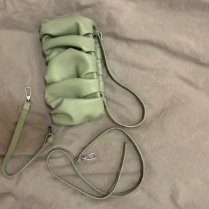 Väska - Liten justerbar väska som går att ha i olika längder. Olivgrön i skinimmitation, nyskick. 