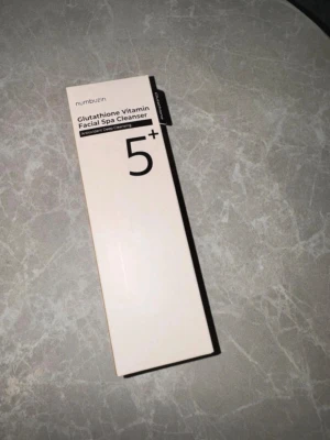 Cleanser Numbuzin  - Numbuzin Glutathione Vitamin Facial Spa Cleanser 5+ är en ansiktsrengöring som kombinerar glutathion och vitaminer för djuprengöring. Förpackningen är ljusbeige med svart text och rymmer 120 ml. Perfekt för dig som vill ha en fräsch och uppfriskande rengöringsrutin.