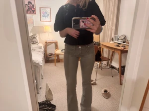 Grå bootcut jeans med broderi - Snygga grå jeans med bootcut passform och coola detaljer på bakfickorna. Byxorna har medelhög midja och är tunna och sköna. Sitter super snyggt!❤️