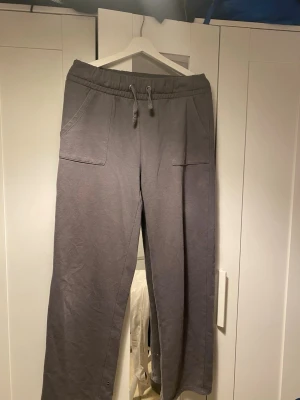 Grå mjukisbyxor från 157 - Grå mjukisbyxor från 157 i storlek M. Byxorna har bred resår i midjan med snörning, två stora fickor fram och två bak. Lite noppriga men i bra skick!🫶🏼