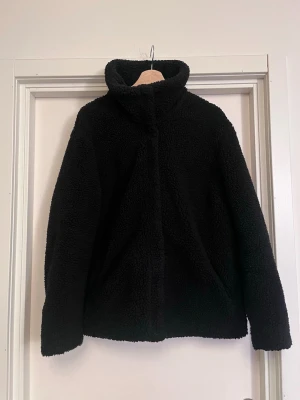 Svart teddyjacka med hög krage - Mysig och varm svart teddyjacka med hög krage. Väldigt varm! Jag har storlek S och jackan är i storlek L, jag har använt den oversize. Mycket bra skick. Säljs på flera sidor, först till kvarn. 