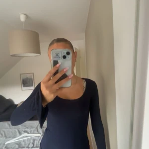 Mörkblå långärmad topp från Gina Tricot - En basic mörkblå långärmad topp från Gina Tricot med rundad urringning. Tillverkad i mjuk bomullsmix som känns skön mot huden. Perfekt att styla med jeans eller kjol för en enkel och clean look. Öppnade armar och så 💕 skriv för mer info 