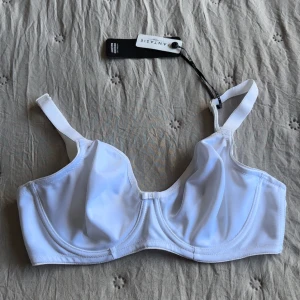 Oanvänd Vit bh från Fantasie 65D - Säljer en vit bh från Fantasie i storlek 65D. Den har justerbara axelband, bygel och mjukt material. Skulle säga att den är en storlek mindre i kupa🫶🏻