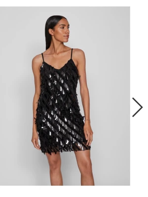 Svart paljettklänning  - Snygg svart kortklänning med smala axelband och glittriga paljetter över hela klänningen.  Helt oanvänd💖