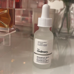 The Ordinary Niacinamide 10% + Zinc 1% - Transparent serum från The Ordinary med niacinamid 10% och zink 1%. Kommer i en frostad glasflaska med vit pipett för enkel applicering. Perfekt för dig som vill ha en fräsch och balanserad hud.