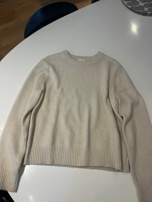 Cremevit stickad tröja från H&M - Cremevit stickad tröja från hm. Bra skick och använd fåtal gånger. Liten i storleken, passar mig som brukar ha S