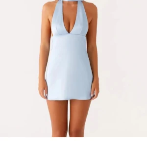 Ljusblå kort klänning - Supersnygg ljusblå kortklänning i satin från peppermayo 🥰finns lite fläckar på bandet runt halsen annars bra skick!