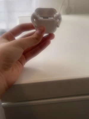 Vita Apple AirPods med laddningsetui - Säljer ett par vita Apple AirPods med matchande laddningsetui. Snygg och kompakt design i blank plast som är enkel att ta med sig överallt. Perfekta för trådlös musik och samtal, smidigt att koppla till iPhone eller andra Apple-enheter.