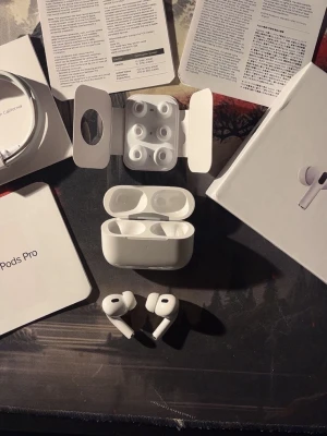 Apple AirPods Pro 2 USB-C - Säljer ett par vita Apple AirPods Pro (2nd Gen) med MagSafe-laddningsetui och USB-C. Inkluderar flera silikonpluggar för perfekt passform och originalförpackning. Grymt ljud, brusreducering och smidig anslutning till iPhone och andra Apple-enheter.