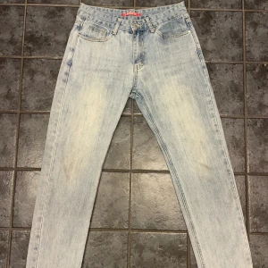 Ljusblå jeans från Lacoste Live W31 L31 - Fräscha ljusblå jeans från Lacoste Live i klassisk femficksmodell. Raka ben, normal passform och en diskret Lacoste-logga på bakfickan. Sköna jeans i 100% bomull med en snygg tvättad look.  Väldigt bra skick! Få slitmärken längst nere på byxorna, bilder kan skickas! Nypris är på 1200  Storleken är W31 L31 - 46 W31 men den passar även 48  Perfekta om du vill ha ett par stilrena och trendiga jeans som funkar till allt.  Priset går absolut att diskutera 😀