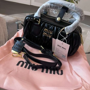 Miu Miu handväska - Helt ny och oanvänd miu miu handväska i äkta läder och extra justerbart axelband. QR-koderna på prislappen och insidan går direkt till miumiu.com. Mått: 25x13cm. Skickas med dustbag