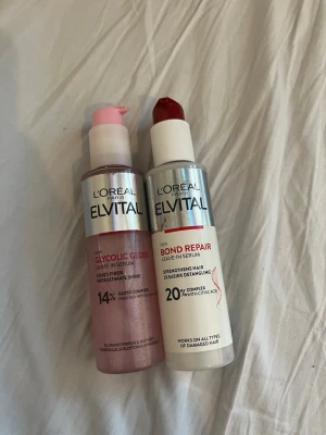 L'Oréal Elvital leave-in serum duo - Två leave-in serum från L'Oréal Elvital: Glycolic Gloss i rosa flaska med pump och Bond Repair i vit flaska med röd pump. Båda är designade för att ge glans och stärka håret. Perfekta för dig som vill ha extra vård och glans till håret. Båda för 100