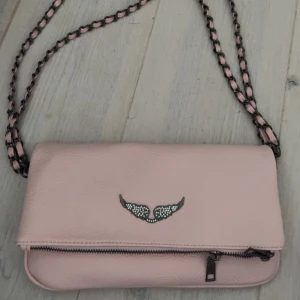 Rosa axelväska med kedjerem - Säljer min rosa Zadig väska, (osäker om den e äkta, köpte den här på Plick), den ser ny ut och har inga defekter💕