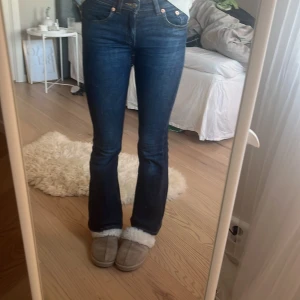 Levi's mörkblå bootcut jeans - Mörkblå jeans från Levi's med klassisk femficksdesign och snygg bootcut passform. Jeansen har hög midja och raka ben som blir lite utsvängda nertill. Tillverkade i slitstarkt denim med snygga kontrastsömmar och kopparfärgade nitar.