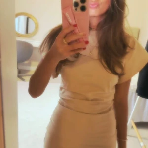 Beige avora klänning (slutsåld) - Säljer en snygg beige kortklänning med markerad midja. Klänningen har rund halsringning och är kortärmad, perfekt för dig som gillar en stilren och trendig look. Passformen är tight och materialet känns mjukt mot huden. Storlek XS men passar mig som har XXS/XS🩷
