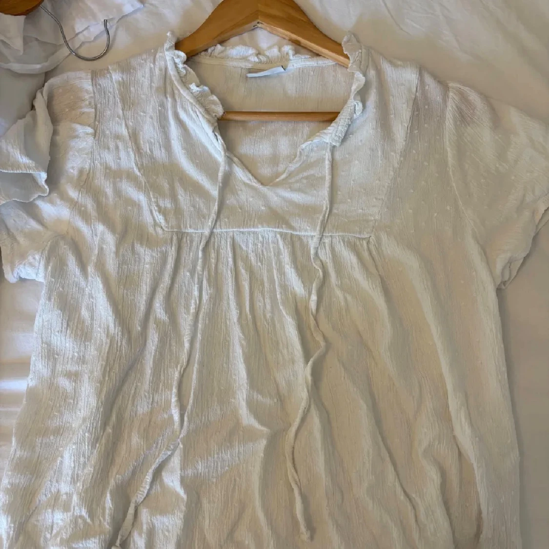 Vit blus med snörning och volang